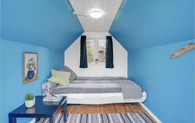 a blue bedroom with a bed and a table at Pet Friendly Home In Spøttrup With Wifi in Spottrup