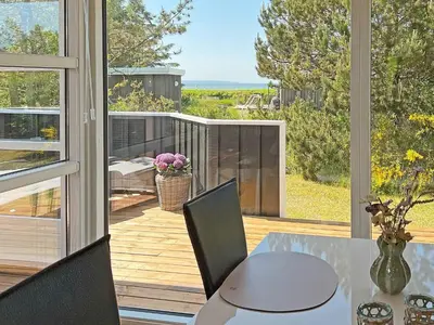 a dining room with a table and a large window at 7 person holiday home in Løgstør-By Traum in Løgsted