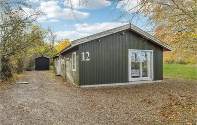 a green building with the number on it at Stunning Home In Nibe With Kitchen in Store Ajstrup