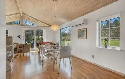 a kitchen and dining room with a table and chairs at Stunning Home In Nibe With Kitchen in Store Ajstrup