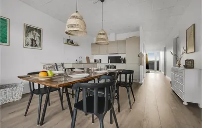 a kitchen and dining room with a wooden table and chairs at Beautiful Home In Thisted With Wifi in Thisted