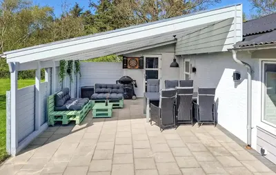a pavilion with chairs and a table on a patio at Lovely Home In Hurup Thy With Sauna in Sønder Ydby