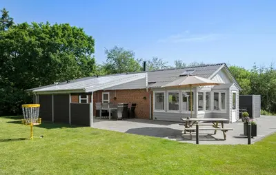 a small house with a picnic table and a grill at Lovely Home In Hurup Thy With Sauna in Sønder Ydby