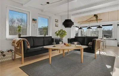 a living room with a table and a couch at Lovely Home In Hurup Thy With Sauna in Sønder Ydby