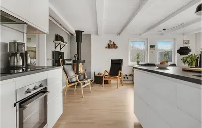 a kitchen with white cabinets and a counter top at Lovely Home In Hurup Thy With Sauna in Sønder Ydby