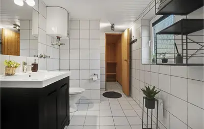 a bathroom with a sink and a toilet at Lovely Home In Hurup Thy With Sauna in Sønder Ydby