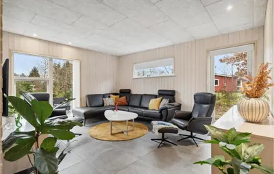 a living room with a couch and chairs and a table at 5 Bedroom Lovely Home In Højslev in Højslev