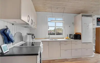 a kitchen with white cabinets and a sink and a window at 3 Bedroom Beautiful Home In Højslev in Højslev