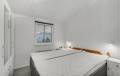 a white bedroom with a large bed and a window at 3 Bedroom Beautiful Home In Højslev in Højslev