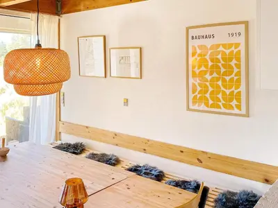 a dining room with a wooden table and a lamp at 6 person holiday home in Blokhus-By Traum in Blokhus