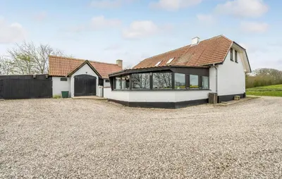 a white house with a brown roof on a gravel driveway at Awesome Home In Bedsted Thy With Wifi in Bedsted Thy