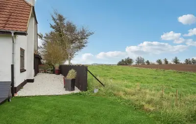 a house with a fence and a grass field at Awesome Home In Bedsted Thy With Wifi in Bedsted Thy