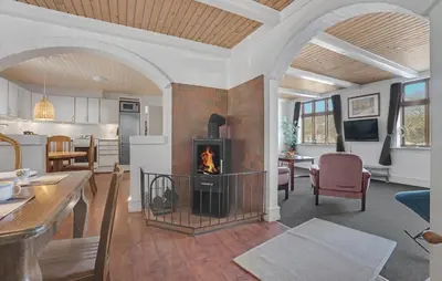a living room with a fireplace in the middle at Awesome Home In Bedsted Thy With Wifi in Bedsted Thy
