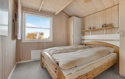a bedroom with a bed in a room with a window at 3 Bedroom Lovely Home In Frøstrup in Frøstrup