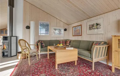 a living room with a couch and a table at 3 Bedroom Lovely Home In Frøstrup in Frøstrup