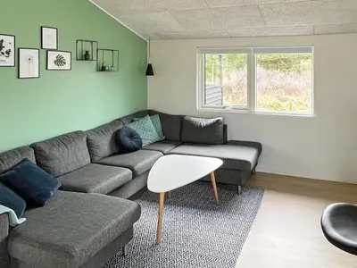a living room with a couch and a table at 6 person holiday home in Saltum-By Traum in Saltum