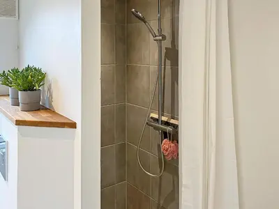 a shower stall in a bathroom with a shower curtain at 6 person holiday home in Saltum-By Traum in Saltum