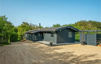a green shed with a dirt road in front at Lovely Home In Hurup Thy With Wifi in Sønder Ydby
