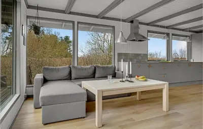 a living room with a couch and a table at Lovely Home In Hurup Thy With Wifi in Sønder Ydby