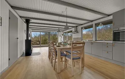 a kitchen and dining room with a table and chairs at Lovely Home In Hurup Thy With Wifi in Sønder Ydby