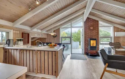 a kitchen and living room with a fireplace at Gorgeous Home In Blokhus With Wifi in Blokhus