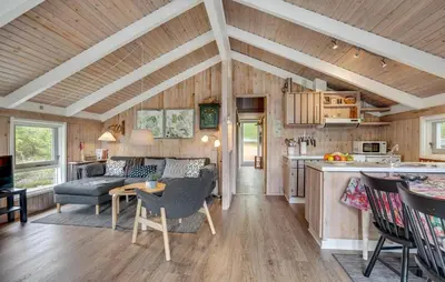 a kitchen and living room with a couch and a table at Gorgeous Home In Blokhus With Wifi in Blokhus