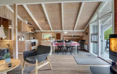 a kitchen and living room with a table and chairs at Gorgeous Home In Blokhus With Wifi in Blokhus