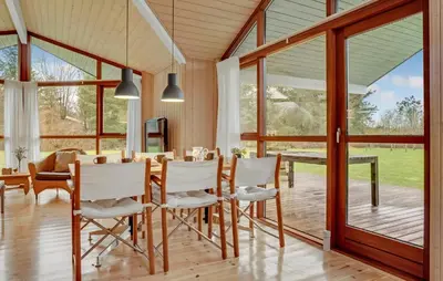 a dining room with a table and chairs and windows at Amazing Home In Spøttrup With Kitchen in Spottrup