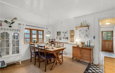 a kitchen with a wooden table and chairs at 2 Bedroom Lovely Home In Højslev in Højslev