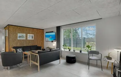 a living room with a couch and a table at 3 Bedroom Cozy Home In Thyholm in Thyholm