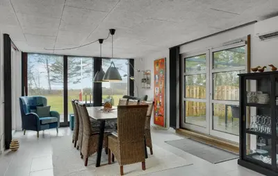a dining room with a table and chairs at 3 Bedroom Cozy Home In Thyholm in Thyholm