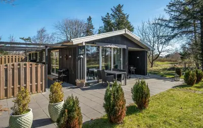 a small cabin with a table and chairs on a patio at 3 Bedroom Cozy Home In Thyholm in Thyholm