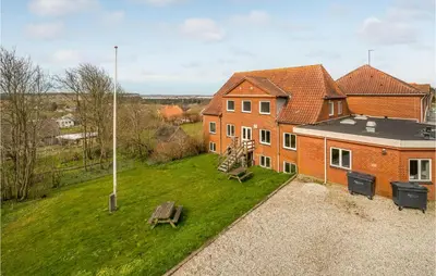 an overhead view of a house with a bench in the yard at 5 Bedroom Stunning Home In Hanstholm in Hanstholm