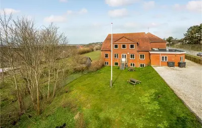 an aerial view of a house on a grass field at 5 Bedroom Stunning Home In Hanstholm in Hanstholm