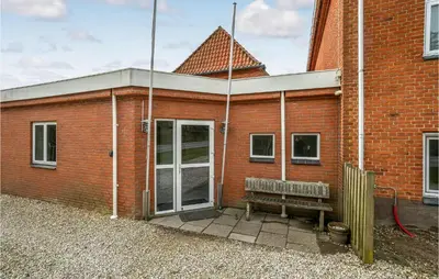 a brick building with a bench in front of it at 5 Bedroom Stunning Home In Hanstholm in Hanstholm