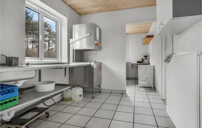 a large white kitchen with a sink and a window at 5 Bedroom Stunning Home In Hanstholm in Hanstholm
