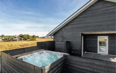a hot tub on the side of a house at Beautiful Home In Thisted With Sauna in Thisted