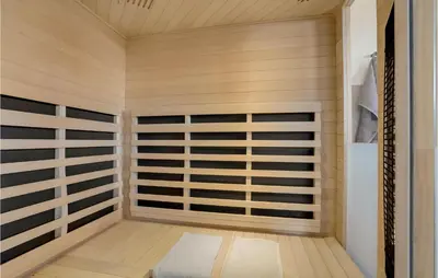 a sauna with wooden walls and a wooden floor at Beautiful Home In Thisted With Sauna in Thisted