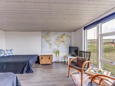 a bedroom with a bed and a map on the wall at Holiday Home Arni - 150m from the sea by Interhome in Lemvig