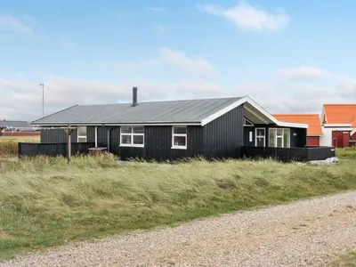 a black house on the side of a road at Holiday Home Arni - 150m from the sea by Interhome in Lemvig