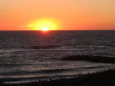 a sunset over the ocean with the sun setting at Holiday Home Beatrice - 150m from the sea by Interhome in Lemvig