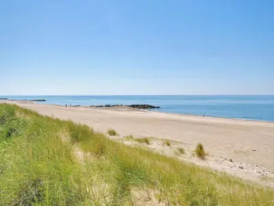 a sandy beach with the ocean in the background at Holiday Home Beatrice - 150m from the sea by Interhome in Lemvig