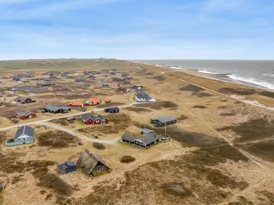 an aerial view of a group of houses and the ocean at Holiday Home Egidia - 50m from the sea by Interhome in Lemvig