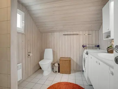 a bathroom with a toilet and a sink at Holiday Home Galmand - 300m from the sea by Interhome in Lemvig