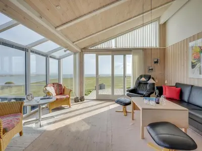 a living room with a view of the ocean at Holiday Home Rajna - 95m to the fjord by Interhome in Lemvig