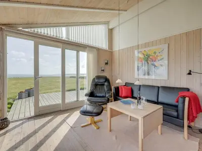 a living room with a couch and a table at Holiday Home Rajna - 95m to the fjord by Interhome in Lemvig