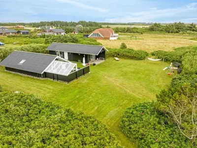 an aerial view of a house with a solar roof at Holiday Home Kamile - 400m from the sea by Interhome in Harboør