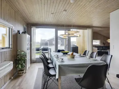 a dining room with a table and chairs at Holiday Home Hebba - 300m from the sea by Interhome in Harboør
