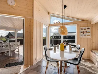 a dining room with a table and chairs at Holiday Home Floriana - 650m from the sea by Interhome in Harboør