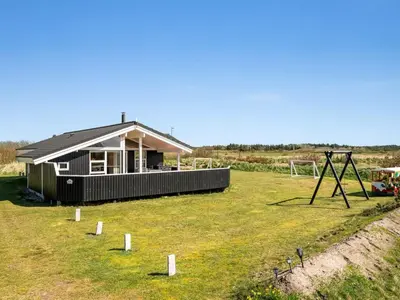 a small house in the middle of a field at Holiday Home Floriana - 650m from the sea by Interhome in Harboør